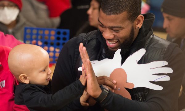 St Jude ambassador Greg Monroe with patient